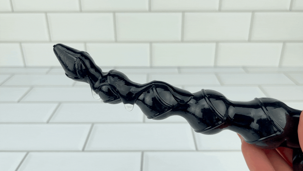 GIF of Vibrating Jelly Anal Beads large black with lubricant dripping off from vibrations 