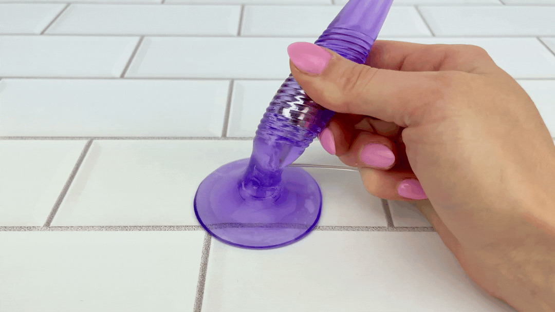 GIF of Vibrating Twister Butt Plug with hand pulling it o demonstrate the suction cup strength 
