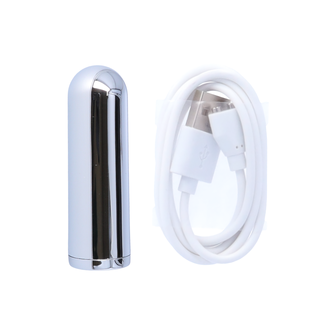 rechargeable bullet from vibrating butt plug as seen next to charging cable 