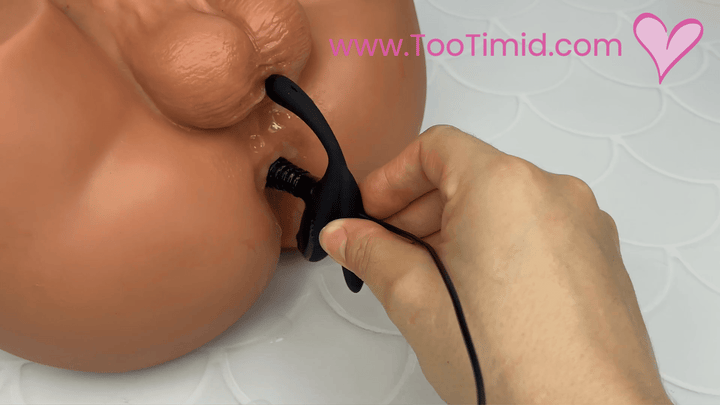 GIF of black prostate stimulator with remote stimulation inside masturbator