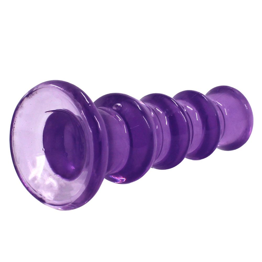Rippled Anal Plug purple laying on its side showing the base suction cup.