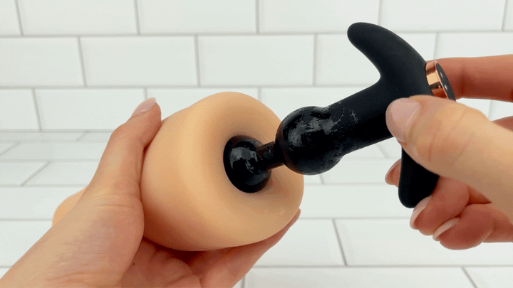 GIF of Macio Silicone Beaded Anal Vibrator Plug being removed from hollow tube 