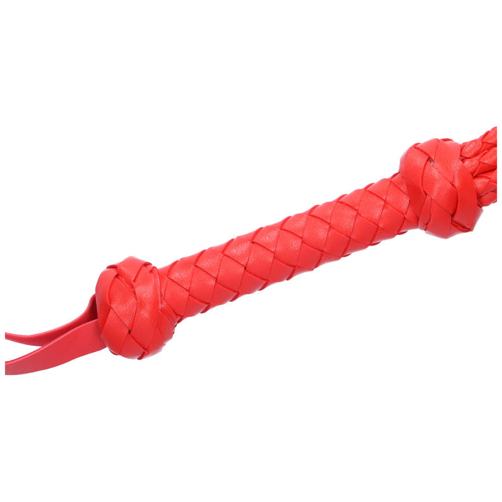 Close-up view of the braided handle of the flogger.