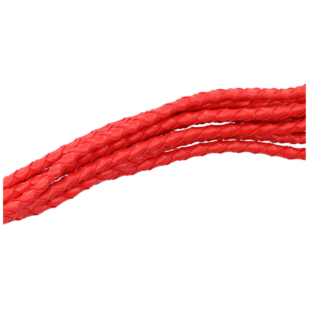 Close-up view of the braided tassels of the flogger.