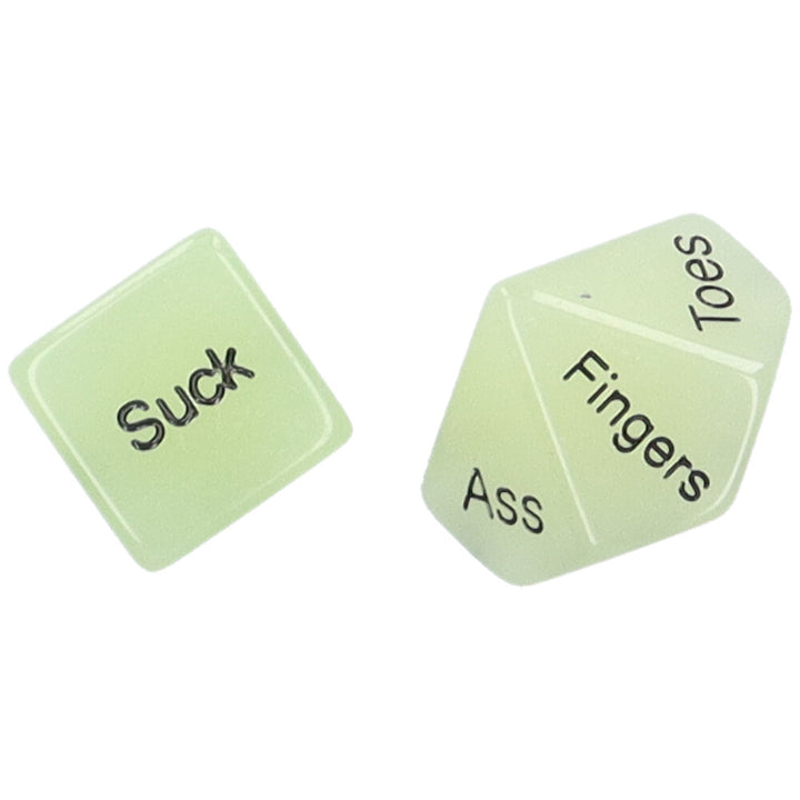 Bird's eye view of a pair of glow-in-the-dark sex dice showing the words "Suck" and "Fingers"
