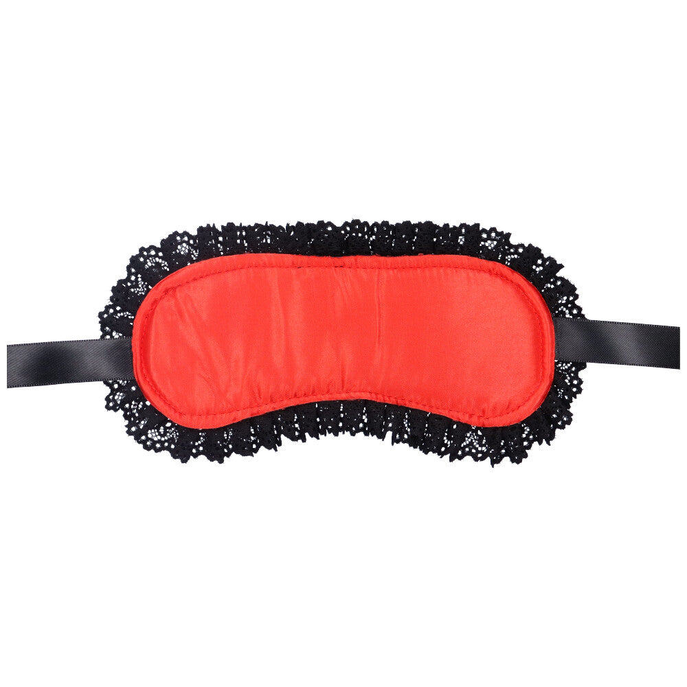 Bird's eye view of the bottom of a red lace blindfold with satin straps.