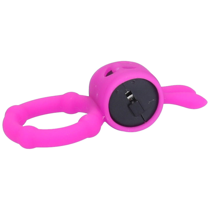Side view of hot pink vibrating cock ring with bunny ears and a happy face made of negative space.