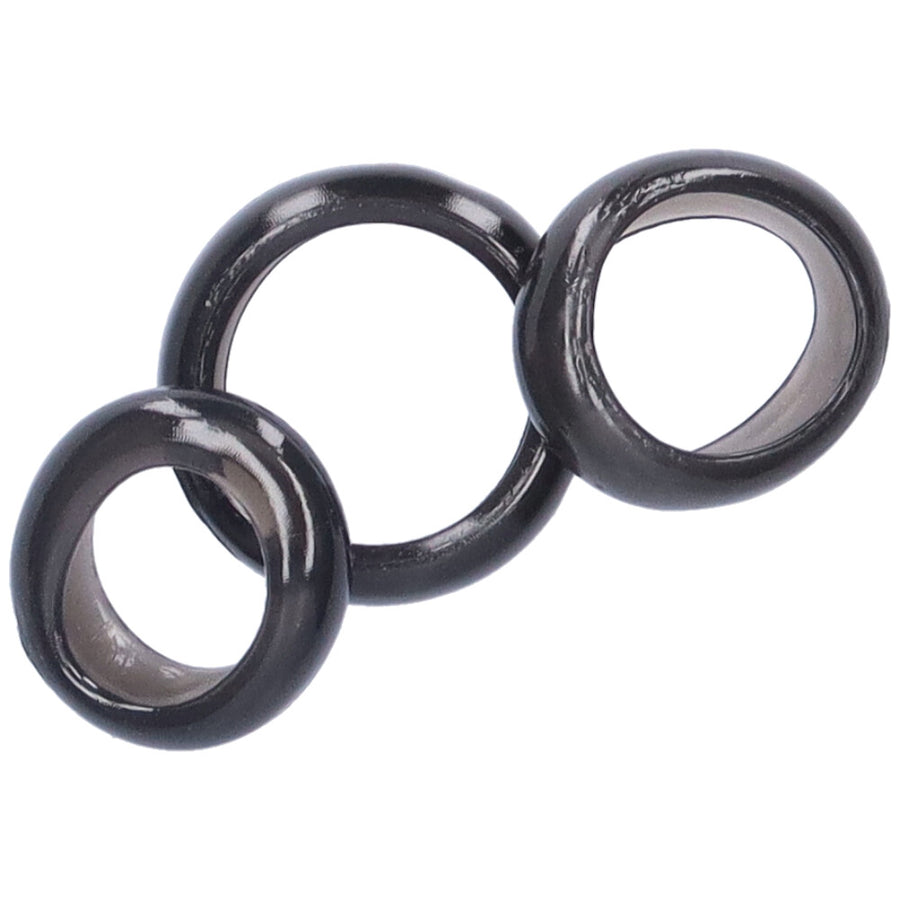 Bird's eye view of 3 black jelly cock rings stacked on top of one another.