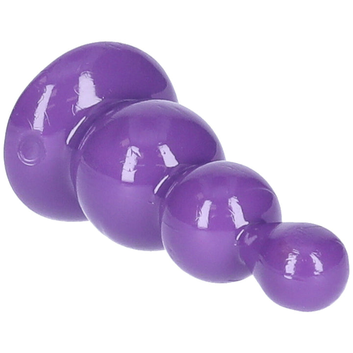 Close-up view of purple beaded anal plug with suction cup base.