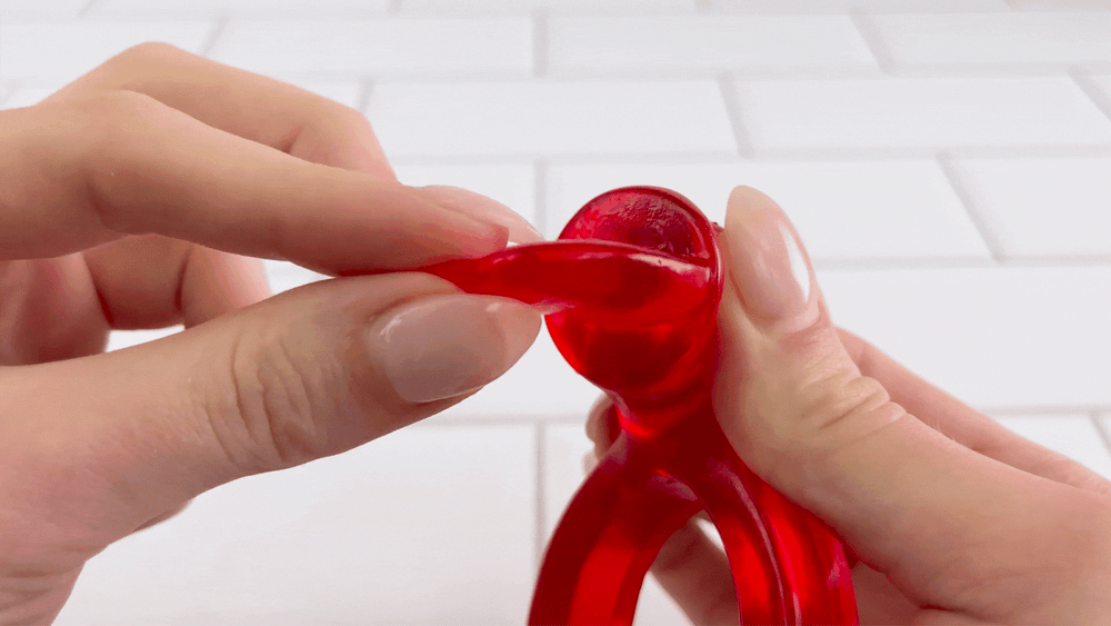 GIF of Clit Flicker Vibrating Cock Ring tongue being bent to show flexibility 