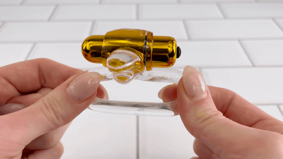 GIF of CalExotics. Pure Gold Double Trouble Enhancer ring being stretched to show flexibility 