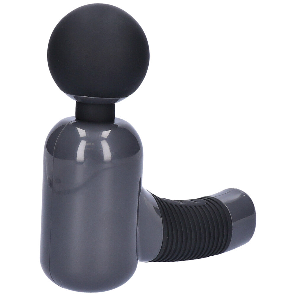 Massage gun lying on it's back facing up.
