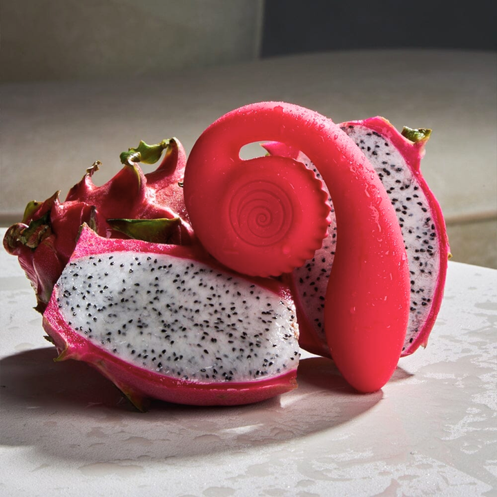 SVibe Snail GIZI Lite Clit & G-Spot Dual Vibrator as seen next to dragonfruit 