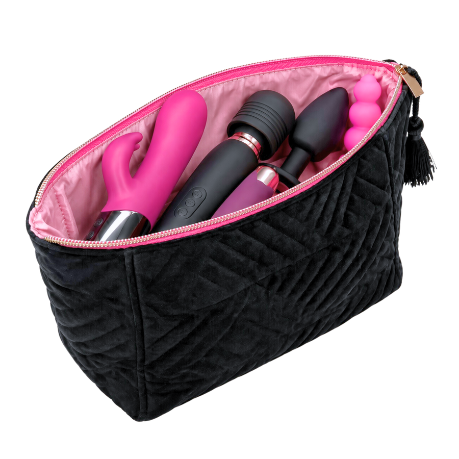 A black quilted zippered pouch with a pink interior, shown open and filled with pink and black intimate massagers and accessories, on a white background.