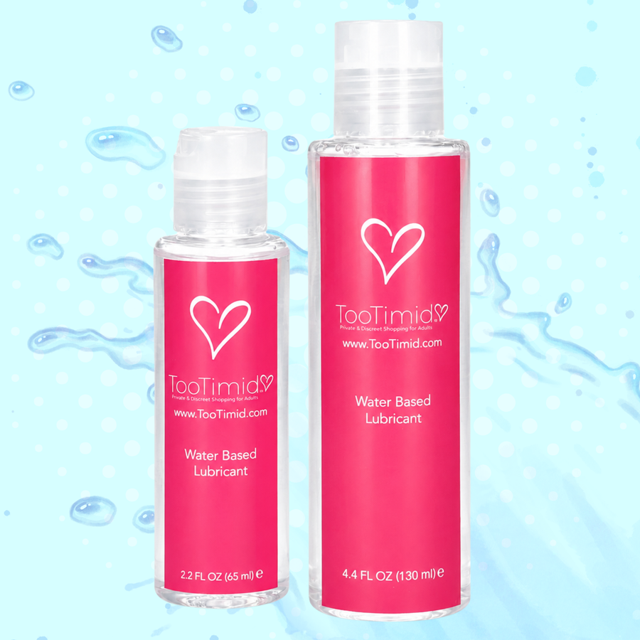 Two clear plastic bottles of TooTimid Water Based Lubricant with bright pink labels, shown against a light blue water droplet background.