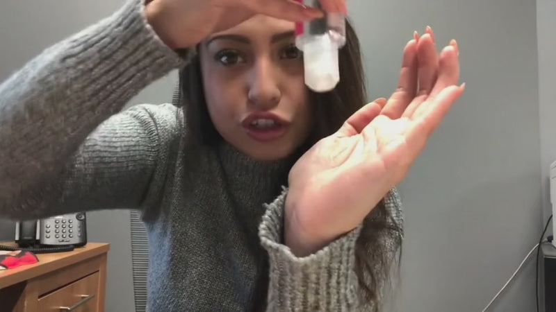 Video with lube being poured into hand and fingers rubbed together to show the consistency of the lube
