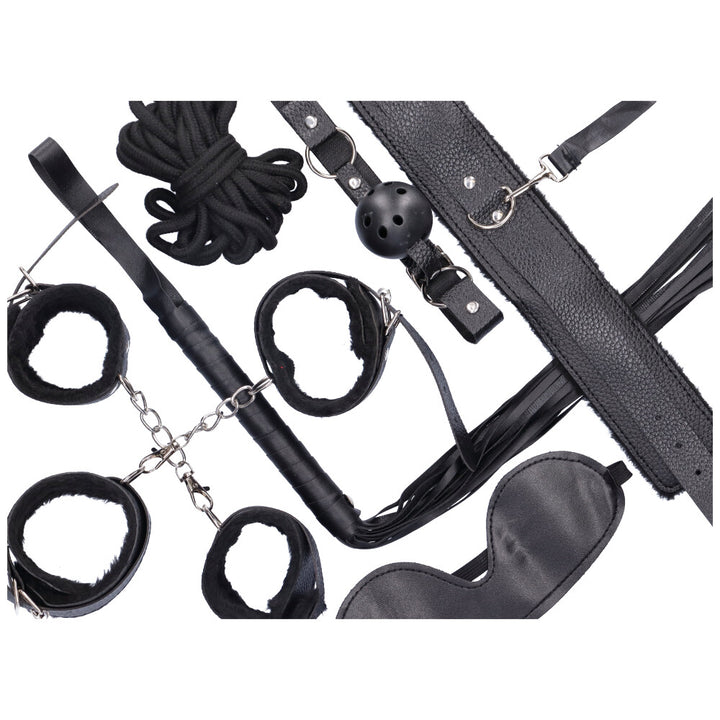Bird's eye view of all elements in bondage kit including: ankle cuffs, wrist cuffs, ball gag, choker with leash, eye mask, rope, and tassel whip.
