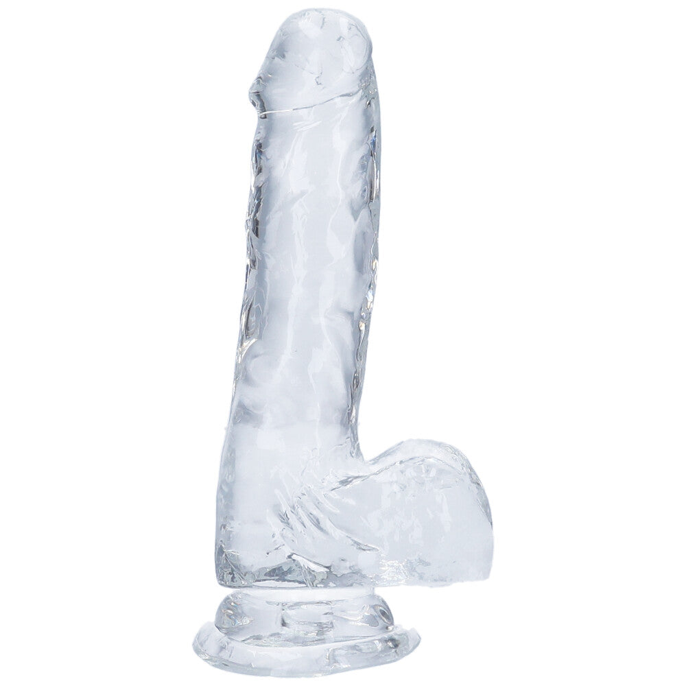 Side view of medium clear realistic suction cup dildo with balls.