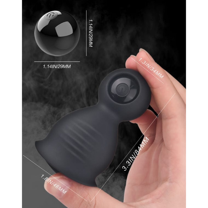 Penis tip massager held in hand with measurements.