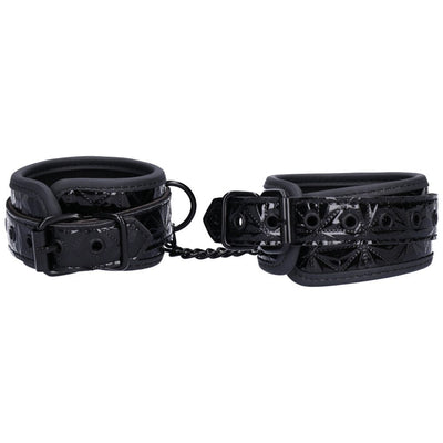 View displaying adjustable clasps of black wrist or ankle cuffs