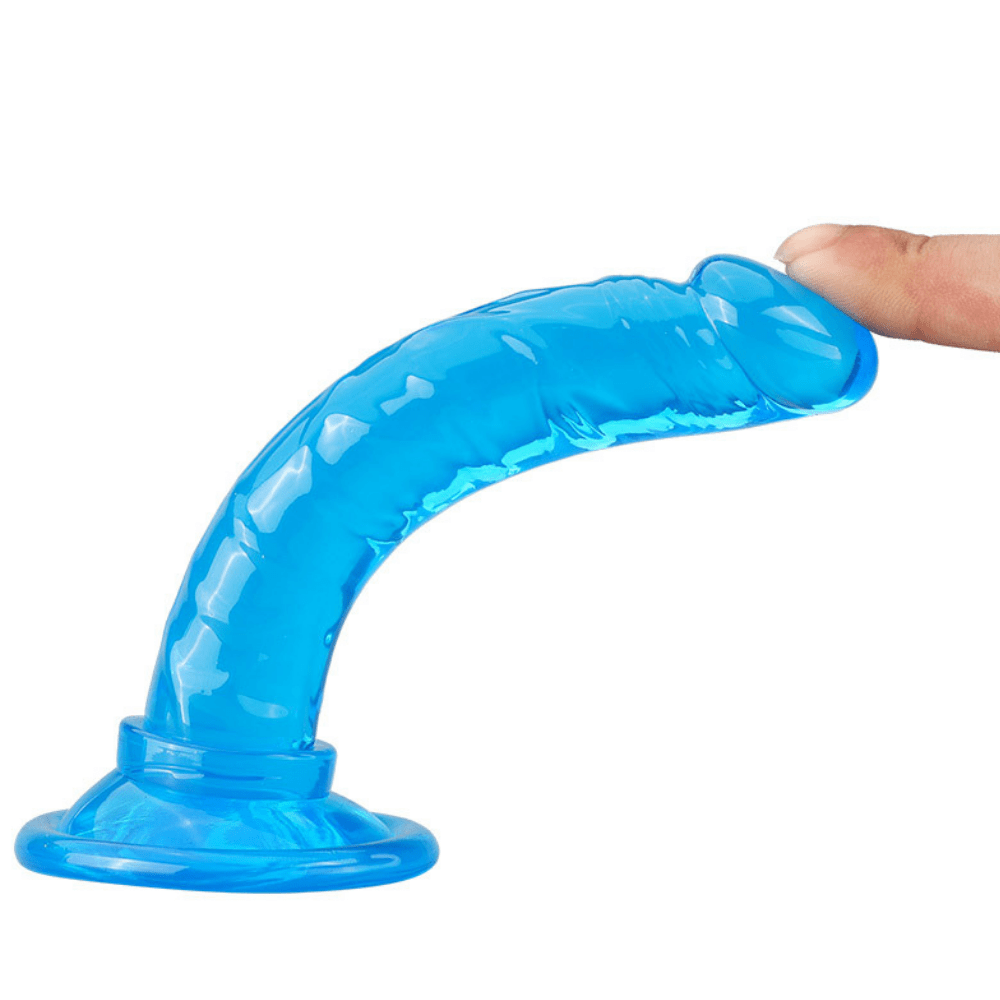 Image of the blue dildo standing upright with a finger holding it down, to show its flexibility.