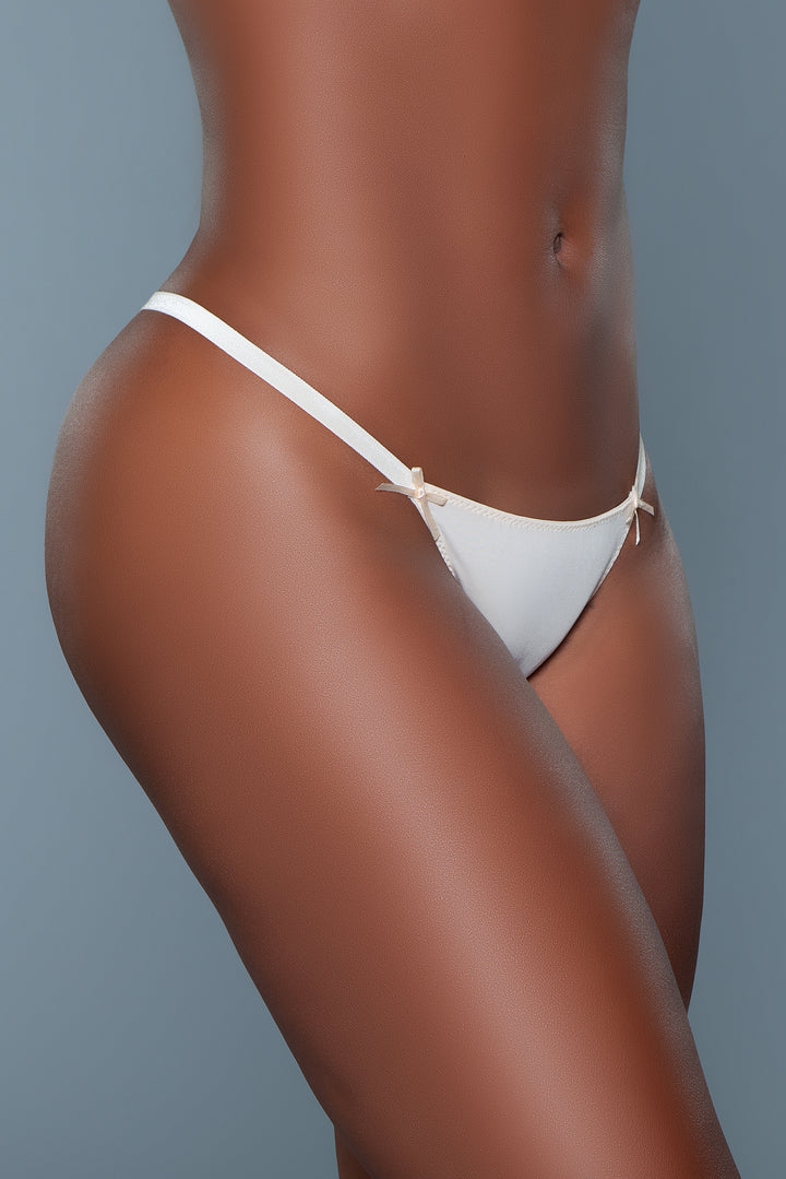 Model facing right side wearing white thong underwear