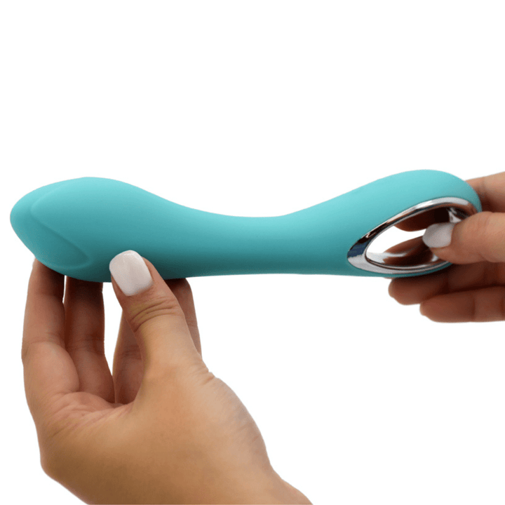Image of hand holding the vibrator from the bottom and top, with the vibrator turned on its side.