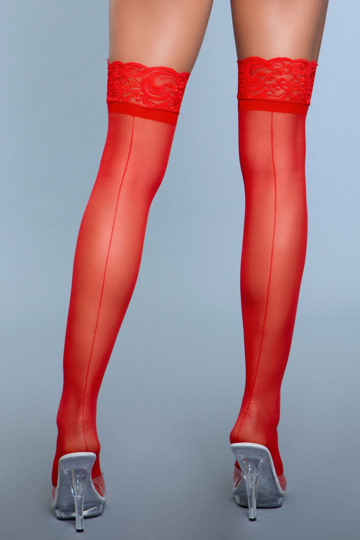 Model facing back wearing red sheer lace top thigh high stockings with backseam