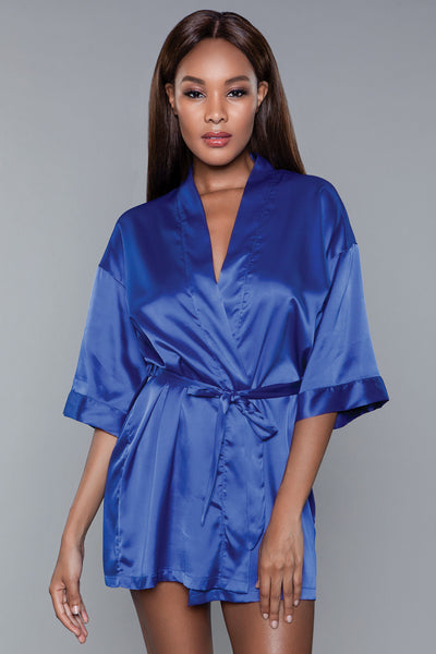 Model facing forward wearing blue satin robe with side pockets. 3/4 sleeves and satin sash front tie