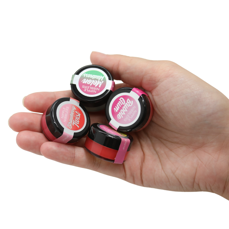 Shot of the Nipple Nibblers in palm of hand to show actual size. This product is about the size of a quarter. Use these to increase sensitivity to your nipples for added stimulation! Increase sexual arousal for yourself and your partner! Choose from 4 yummy flavors!