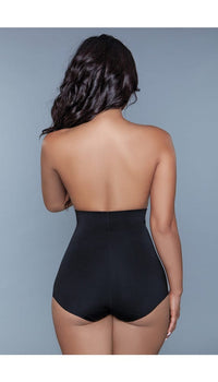 Model wearing seamless high-waisted tummy control body shaper in black facing back