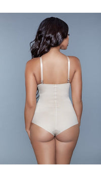 Model wearing seamless bodysuit body shaper with adjustable straps, and snap bottom closure in beige facing back