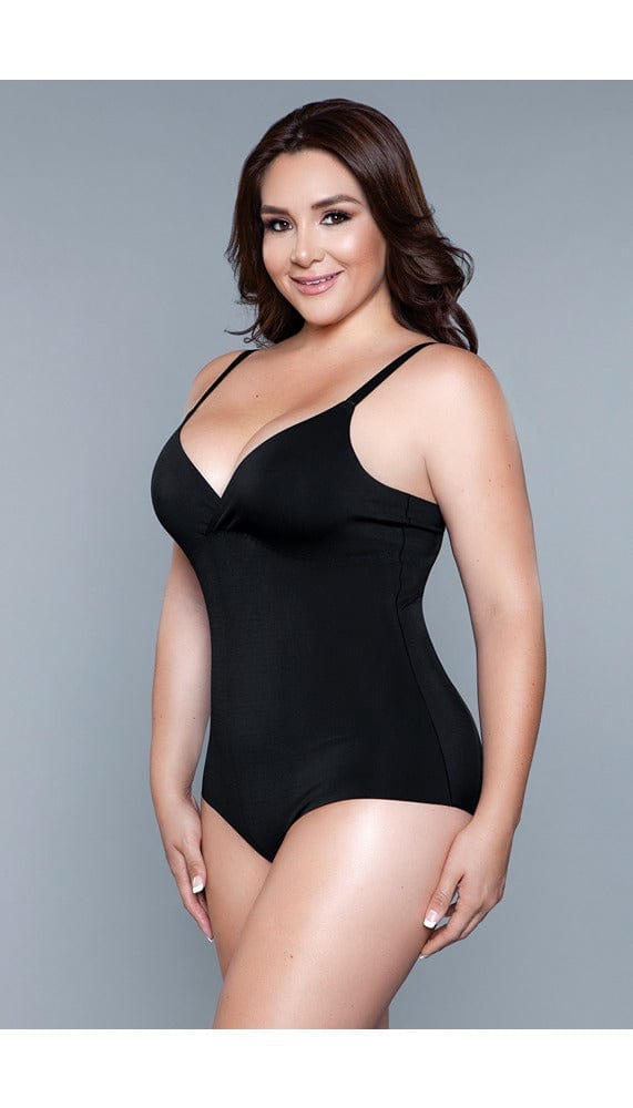 Model wearing seamless bodysuit body shaper with adjustable straps, and snap bottom closure in black facing front left