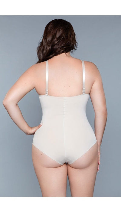 Model wearing seamless bodysuit body shaper with adjustable straps, and snap bottom closure in beige facing back