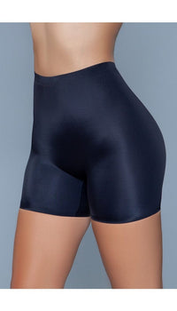Model wearing seamless mid waist and anti-chafing slip shorts in black facing front left