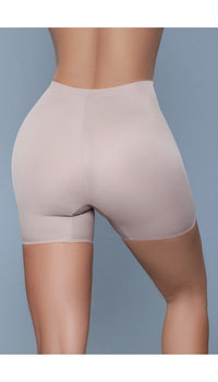 Model wearing seamless mid waist and anti-chafing slip shorts in beige facing back