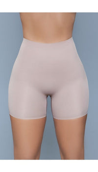 Model wearing seamless mid waist and anti-chafing slip shorts in beige facing forward