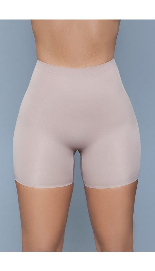 Model wearing seamless mid waist and anti-chafing slip shorts in beige facing forward
