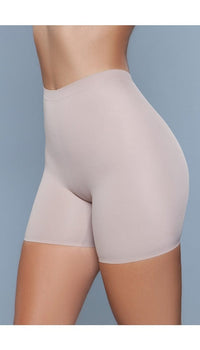 Model wearing seamless mid waist and anti-chafing slip shorts in beige facing left
