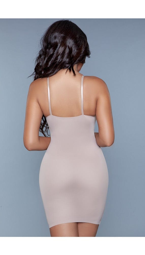 Model wearing seamless deep-v half-slip dress body shaper with adjustable strap in beige facing back