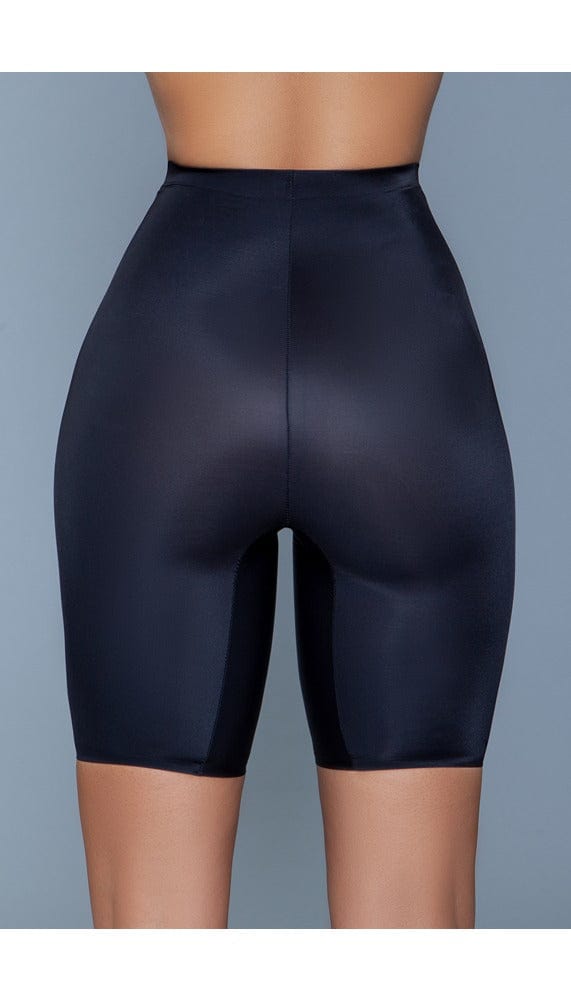 Model wearing seamless mid-waist mid-thigh anti-chafing slip shorts in black facing back