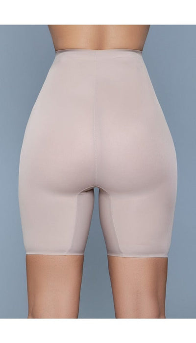 Model wearing seamless mid-waist mid-thigh anti-chafing slip shorts in beige facing back