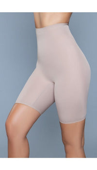 Model wearing seamless mid-waist mid-thigh anti-chafing slip shorts in beige facing front left