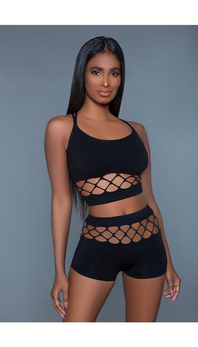 2 pc silk fishnet set that includes a tank crop top with crisscross cami straps and a pair of high-waisted booty shorts in black facing forward