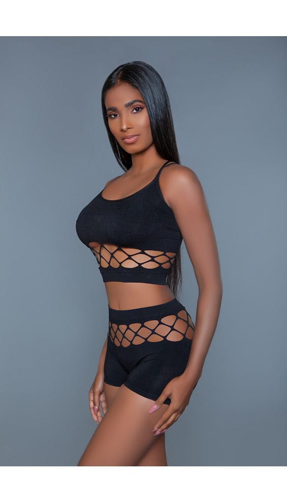 2 pc silk fishnet set that includes a tank crop top with crisscross cami straps and a pair of high-waisted booty shorts facing front left in black