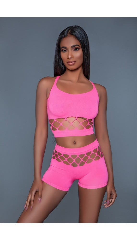 2 pc silk fishnet set that includes a tank crop top with crisscross cami straps and a pair of high-waisted booty shorts in pink facing forward