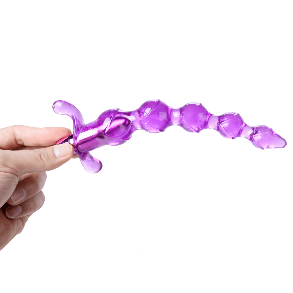 Image of a hand holding the large purple anal bead.