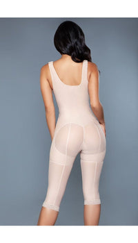 Model wearing open bust bodysuit shapewear with tummy control and butt lifting features, adjustable straps, inner hooks and zipper closure and open crotch in beige facing back