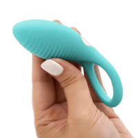 Image of the cock ring being held in hand, turned from the side.