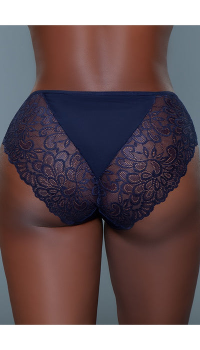 Back view of navy blue high-rise briefs with a lace floral design and a triangle of solid colored fabric coming down from the waist.